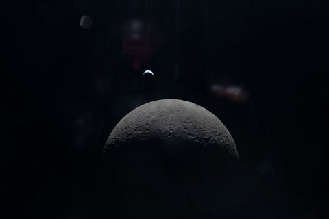 Christina Koch looks back at Earth from the Orion spacecraft during the Artemis II mission.