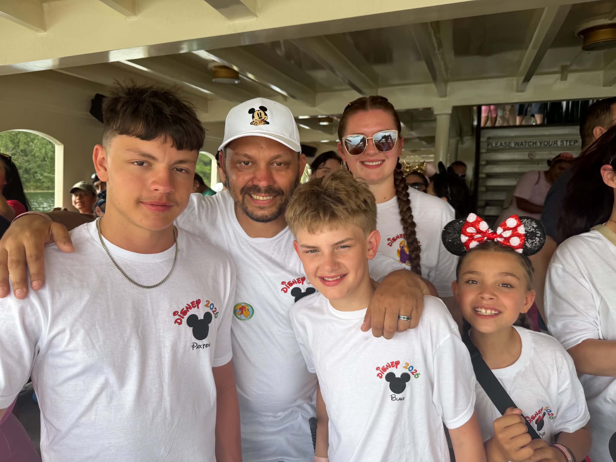 Family in matching Disney 2026 shirts on the ferry heading to Magic Kingdom