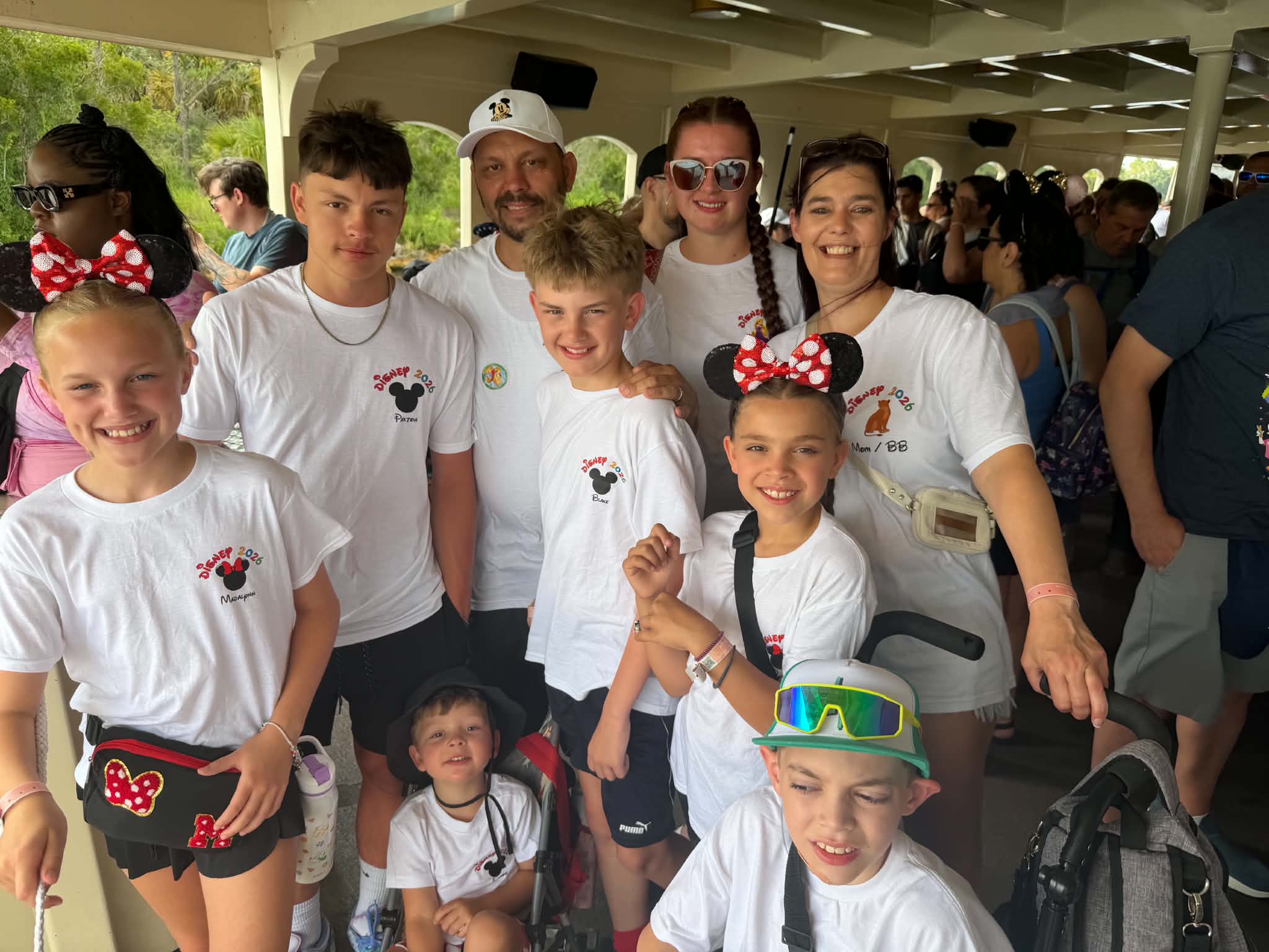 Large family group on the ferry in matching Disney 2026 shirts