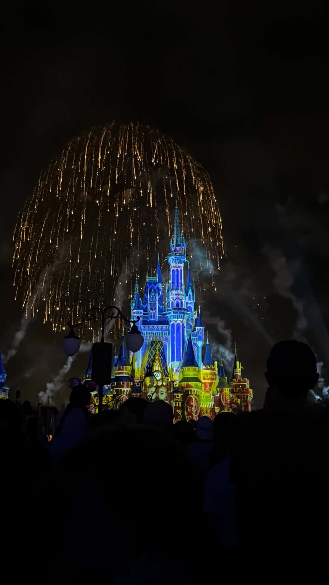 Final golden cascade of fireworks over Cinderella Castle