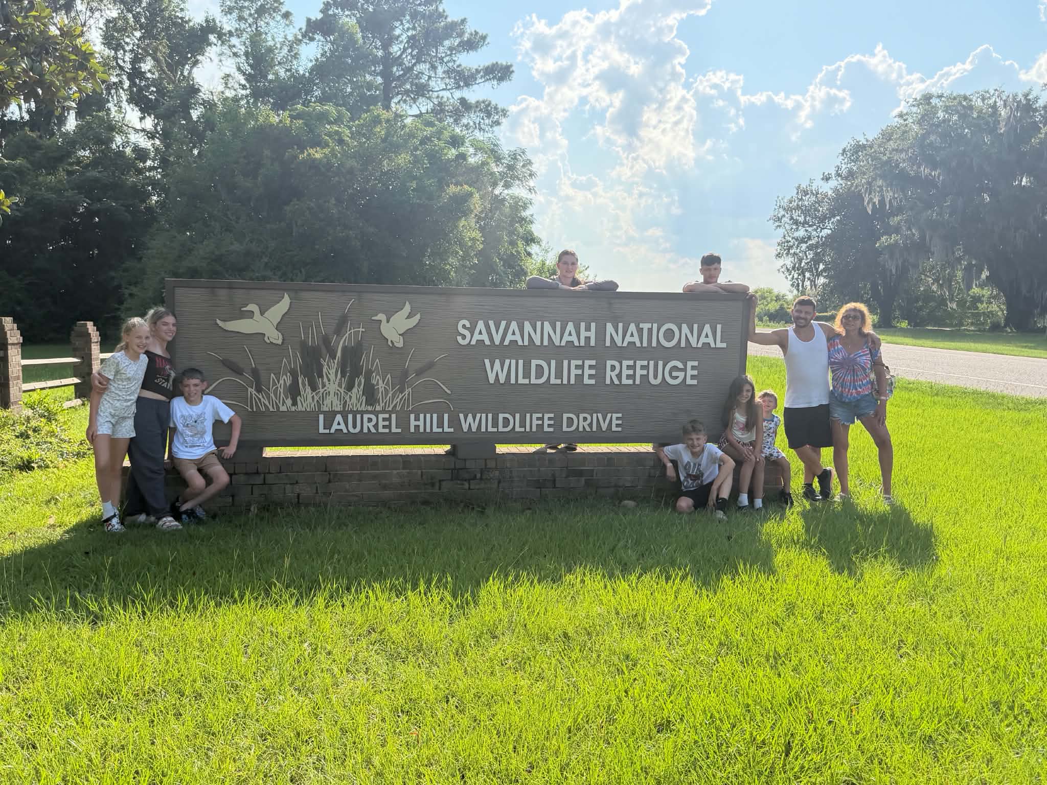 Bright clear group portrait at the Savannah National Wildlife Refuge sign