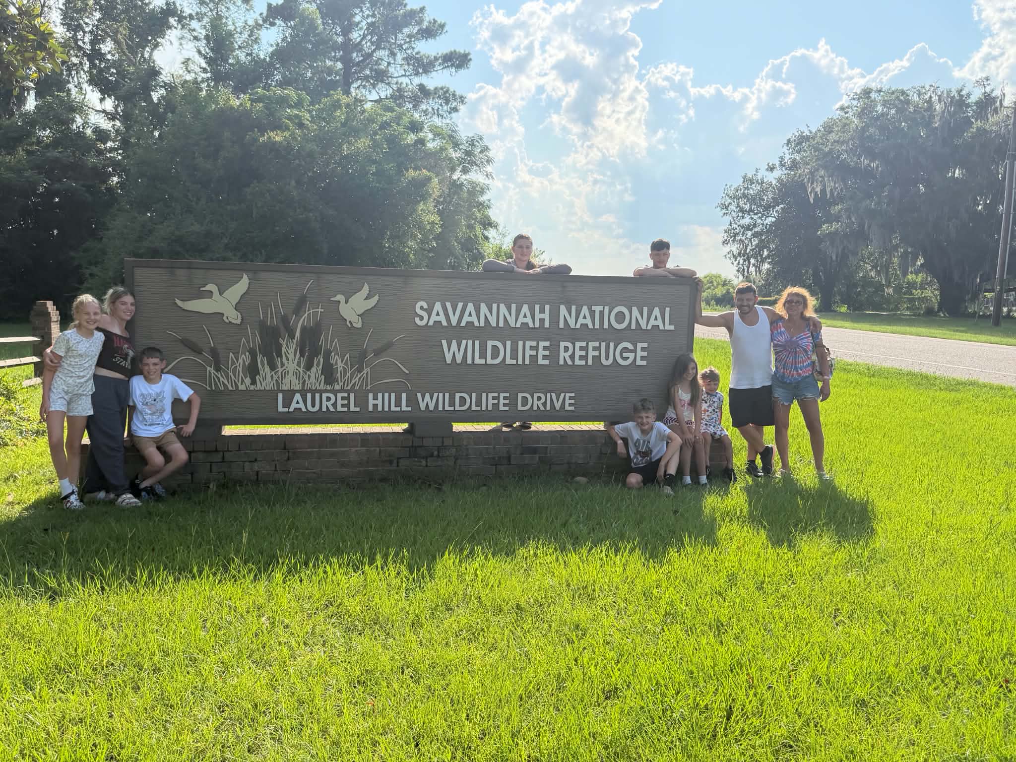 Family posing at the Savannah National Wildlife Refuge sign