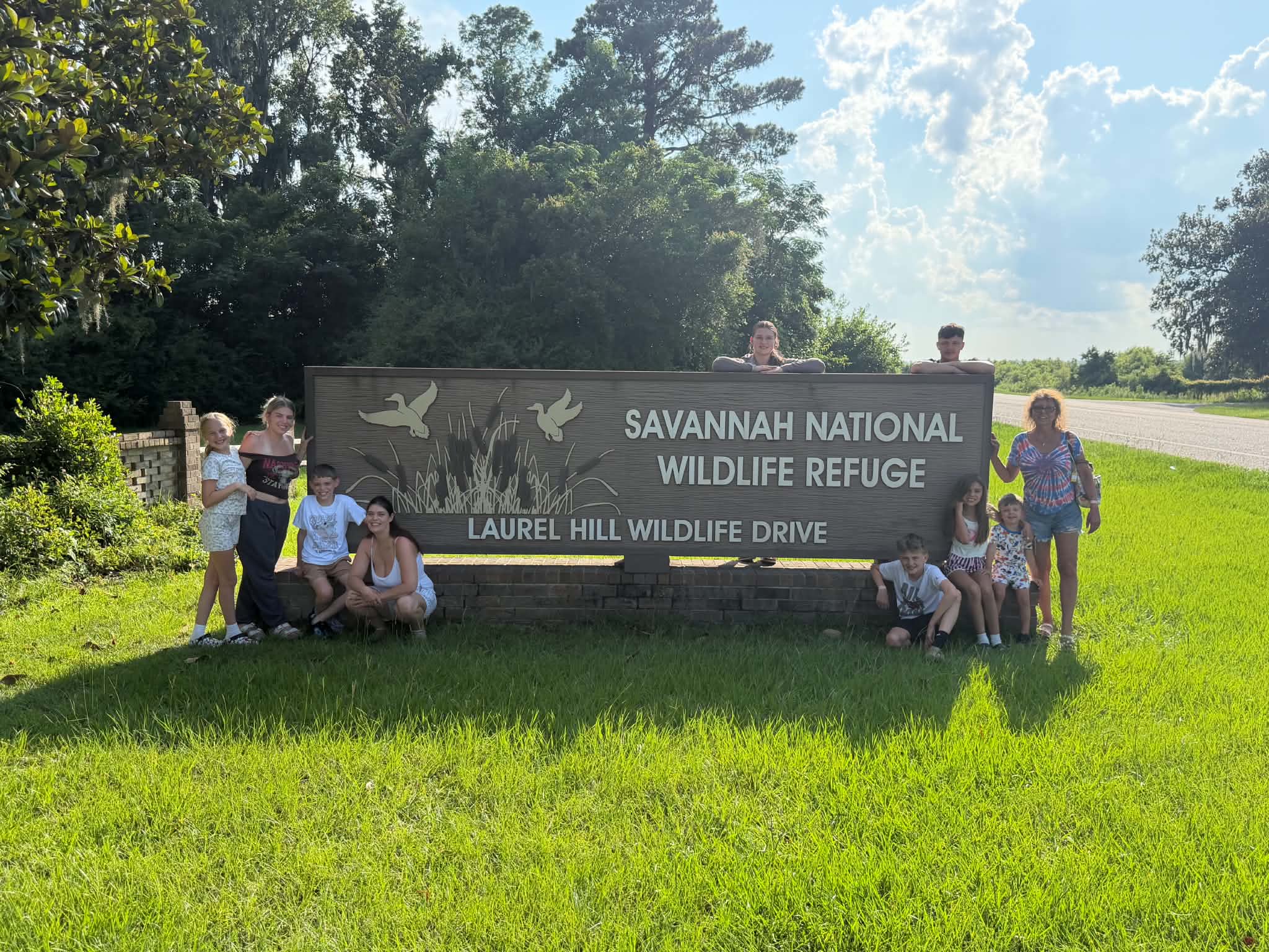 Family group photo at the Savannah National Wildlife Refuge entrance sign